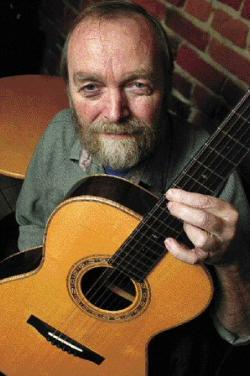 Oskar Graf holding one of his handcrafted guitars